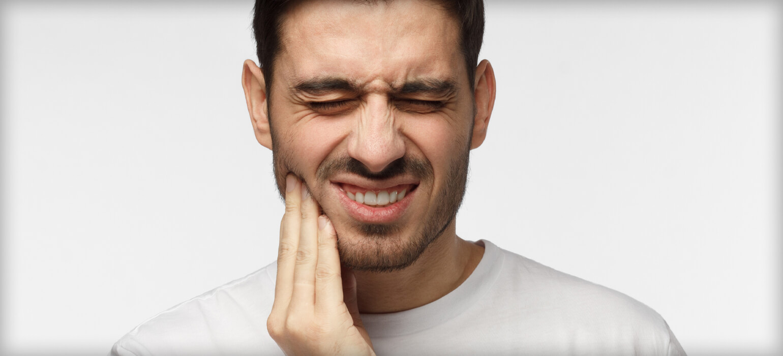 ourservices_tmj man wincing in pain
